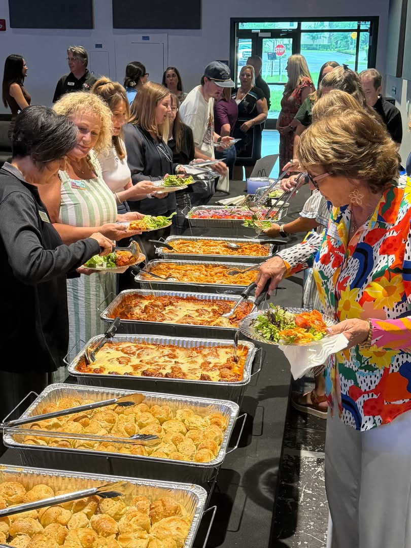 Guests serving themselves from a Stefano's catered buffet at an event